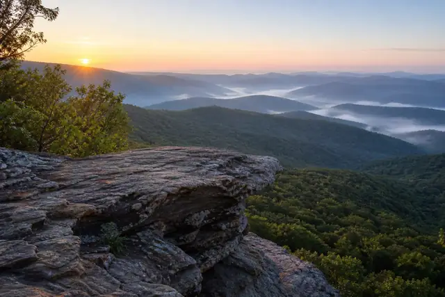 Sunrise over forested Alabama ridges from a sandstone overlook